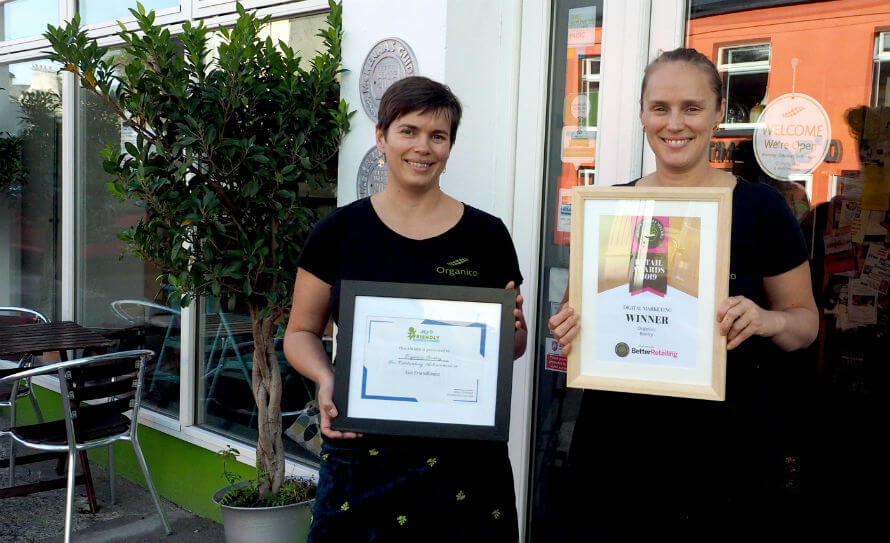 Hannah and Rachel Dare standing outside their business, Organico, with their recent awards