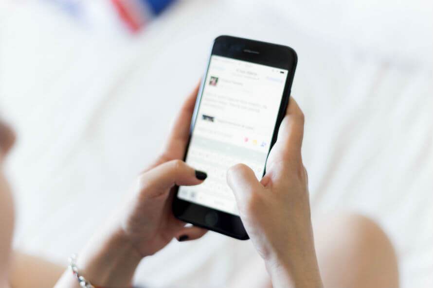 Hands of woman holding and using her mobile phone