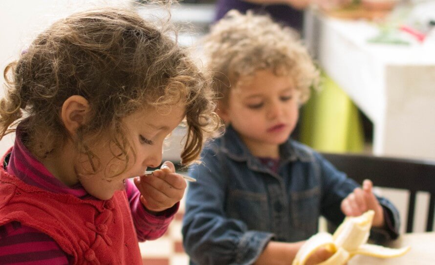 Two kids eating at a table